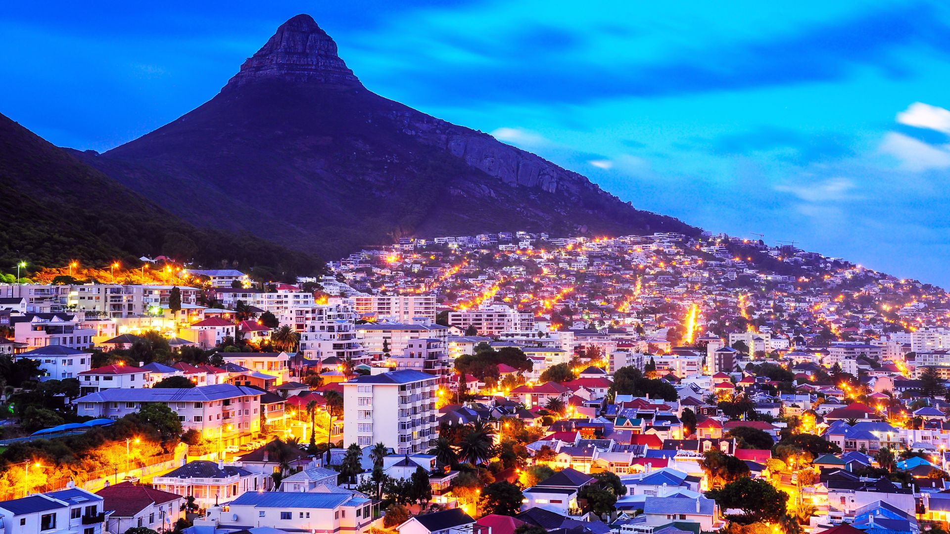 Residential homes in Cape Town at night with Lion's Head in the background — home extensions and renovations by SK Projects & Investments